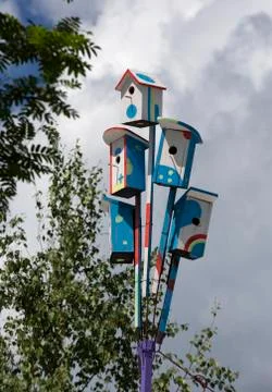 Colorful nesting boxes on blue sky Stock Photos