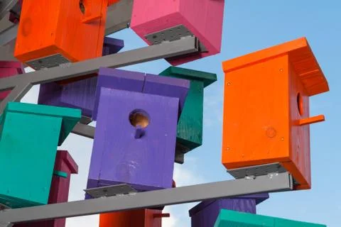 Colorful nesting boxes on blue sky Stock Photos