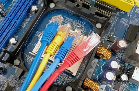 Colorful network cable and computer motherboard Stock Photos