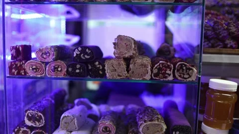 Colorful nut dessert rolls display Stock Footage 331770919