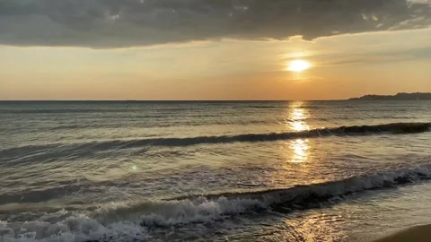 Colorful ocean beach sunset  with deep blue, red, yellow sky and sun rays. .. Stock Footage 276428804