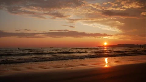 Colorful ocean beach sunset  with deep blue, red, yellow sky and sun rays. .. Stock Footage 276429631