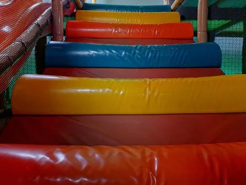 Colorful padded step bridge inside a children's indoor soft play playground Stock Photos