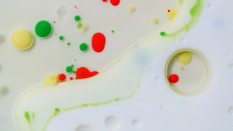 Colorful paint bubbles spread on surface. Oil ink spheres drops and mixing Stock Footage 128749768