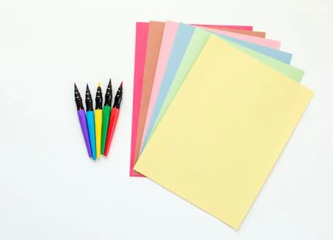 Colorful paint pens with multicolored construction paper Stock Photos