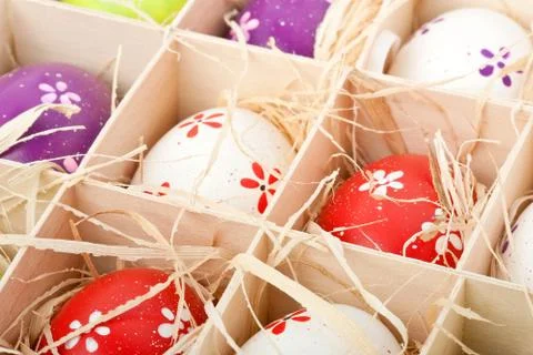 Colorful painted easter eggs assorted in a wodden box Stock Photos