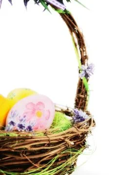 Colorful painted easter eggs in basket Stock Photos