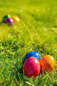 Colorful painted Easter eggs in the bright fresh green grass, concept for Easter Stock Photos
