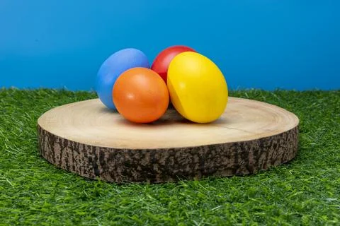 Colorful Painted Easter Eggs on Green Artificial Grass with Blue Background Stock Photos