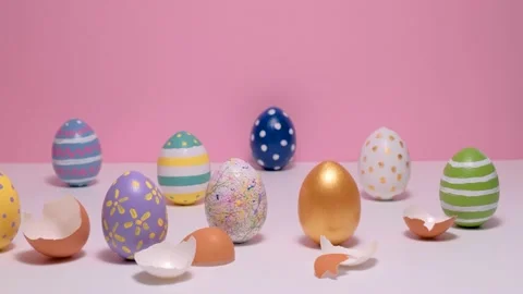 Colorful painted Easter eggs on the pink table. Eggs colored on a pink Stock Footage 151905307