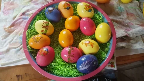 Colorful painted easter eggs with stickers, decorated bowl, close up from above Vídeos de archivo 76281176