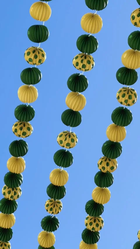 Colorful paper lanterns waving in the wind against a clear blue sky Stock Footage 346596337