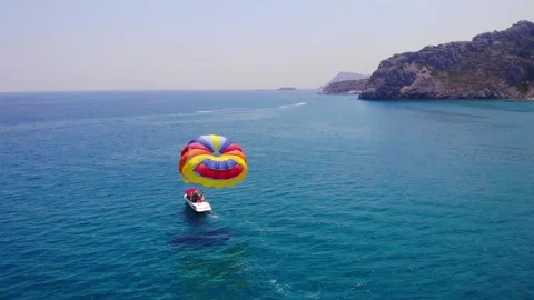 Colorful Parachute Pulled By A Small Boat With Tourists Riding In The Sea. Video stock 202260187