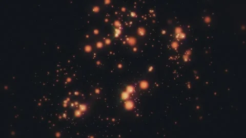 Colorful particles drift through a dark backdrop Stock Footage 310041234