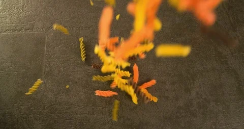 Colorful Pasta falling on table Top view 4K Stock Footage 104059873
