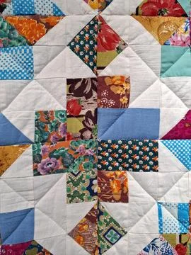 Colorful patchwork quilt featuring floral and geometric patterns made from .. 写真素材