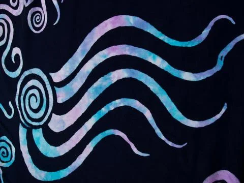 Colorful pattern on black fabric batik as background 스톡 사진