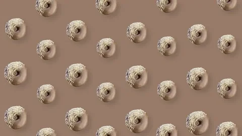 Colorful pattern of chocolate donuts isolated on brown background with shadows Stockbeeldmateriaal 167479354