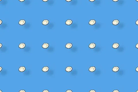 Colorful pattern of coconuts on blue background with shadows. Top view. Flat lay Foto stock