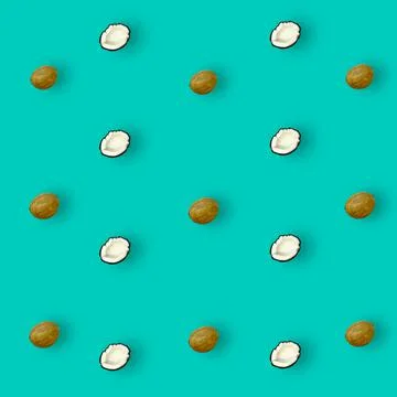 Colorful pattern of coconuts on turquoise background with shadows. Top view Stock Photos