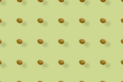 Colorful pattern of coconuts on yellow background with shadows. Top view. Flat Stock Photos