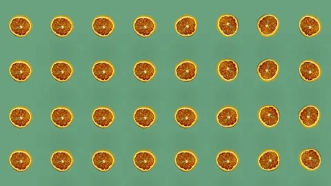Colorful pattern of dried grapefruit slices on green background. Seamless Stock Footage 167486462
