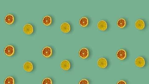 Colorful pattern of dried grapefruits and oranges slices on green background Video stock 167477648