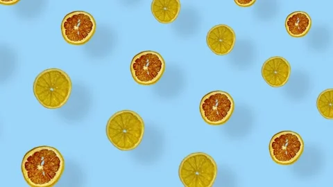 Colorful pattern of dried grapefruits and oranges slices on blue background with Stock Footage 167487117