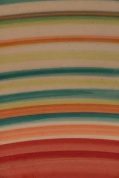 The colorful pattern on the edge of a handmade plate. Stock Photos