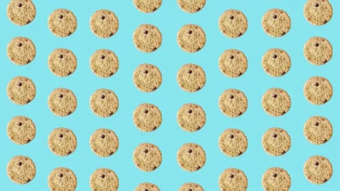 Colorful pattern of fresh chocolate chip cookies on blue background. Seamless Stock Footage 167484651