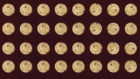 Colorful pattern of fresh chocolate chip cookies on dark background. Seamless Stock Footage 167487115