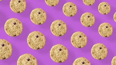 Colorful pattern of fresh chocolate chip cookies on pink background. Seamless Stock Footage 167488262