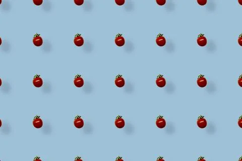 Colorful pattern of fresh red tomatoes on blue background with shadow. Top view 스톡 사진