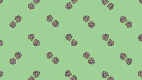 Colorful pattern of fresh rotating chocolate chip cookies on green background Video stock 167489021