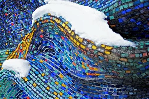 Colorful pattern of geometric mosaic old wall from smalt. With snow. Stock Photos