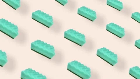Colorful pattern of green kitchen sponges on beige background with shadows Stock Footage 167487078