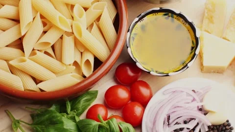 Colorful pattern of italian pasta, tomatoes, sauce, penne pasta ingredients Stock Footage 250352272
