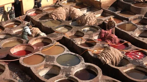Colorful pattern of leather dyeing vats in tannery Fez Morocco Stock Footage