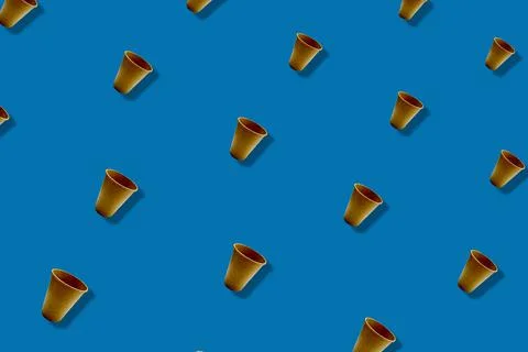 Colorful pattern of paper drinking cups on blue background with shadows. Top Stock Photos