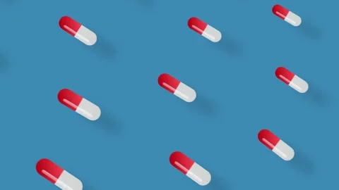 Colorful pattern of pills on blue background with shadows. Seamless pattern with Stock Footage 169241506