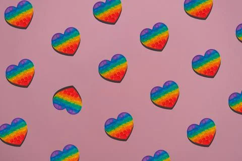 Colorful pattern pop it on pink background, trendy antistress toy Stock Photos