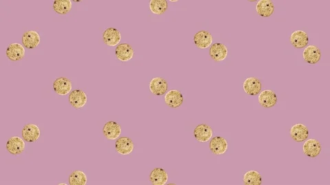 Colorful pattern of rotating fresh chocolate chip cookies on pink background Stock Footage 167489003