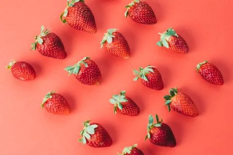 Colorful pattern of strawberries on red background. Top view Stock Photos