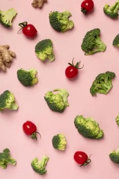 Colorful pattern of tomatoes, broccoli, ginger on a pink backgro Stock Photos