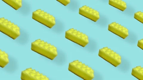 Colorful pattern of yellow kitchen sponges on blue background with shadows Stock Footage 167486897