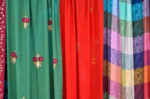 Colorful patterned fabrics hanging in a row Stock Photos