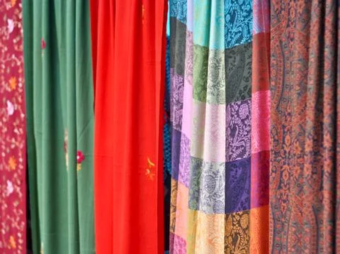 Colorful patterned fabrics hanging in a row Stock Photos