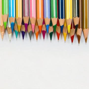 Colorful Pencils Arrayed on White Background Stock Photos