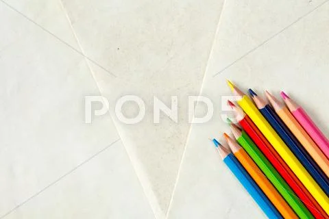 Colorful pencils on paper background Stock Photos
