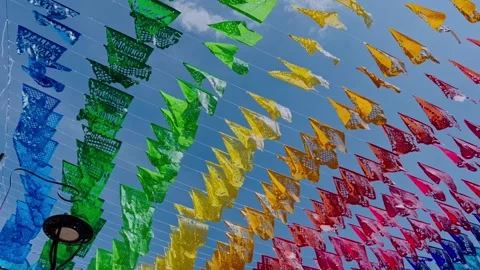 Colorful Pennant Flags Hanging in Rows Against a Bright Blue Sky Stock Footage 345365487